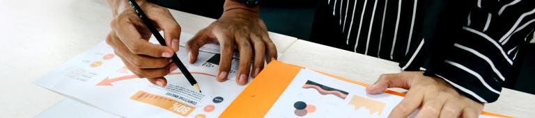 Human hands touching and pointing at statistics. Photo by UX Indonesia on Unsplash